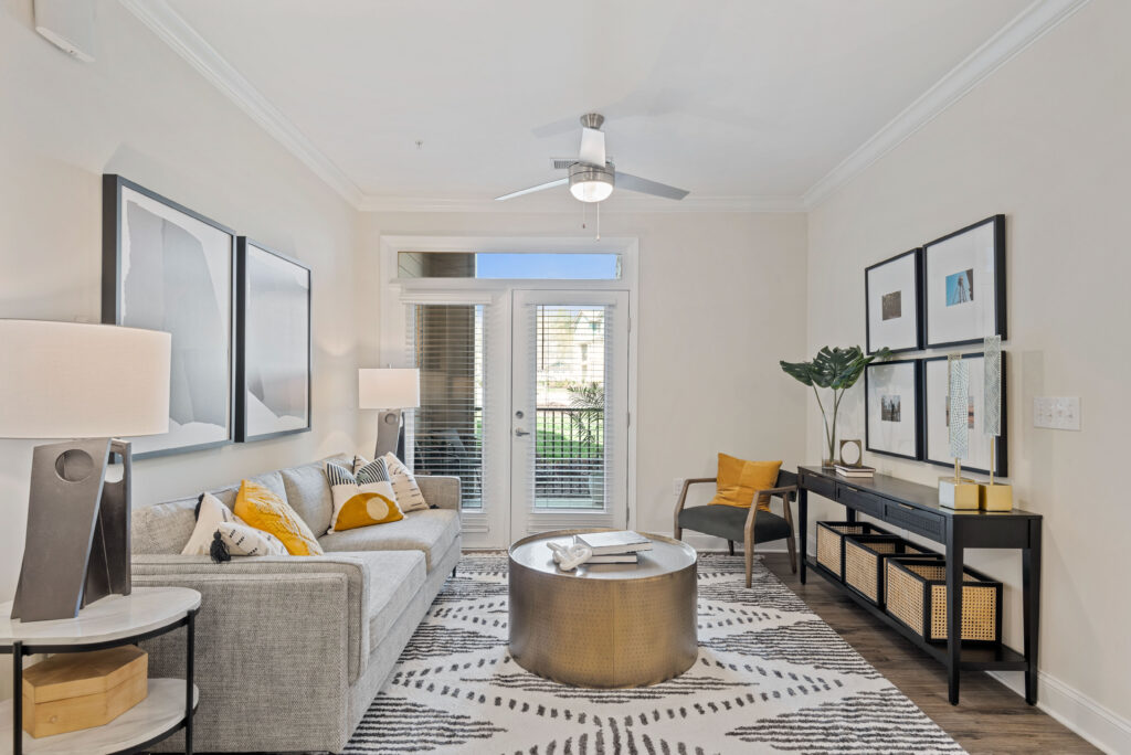 Living room with modern furnishings, door leading to patio