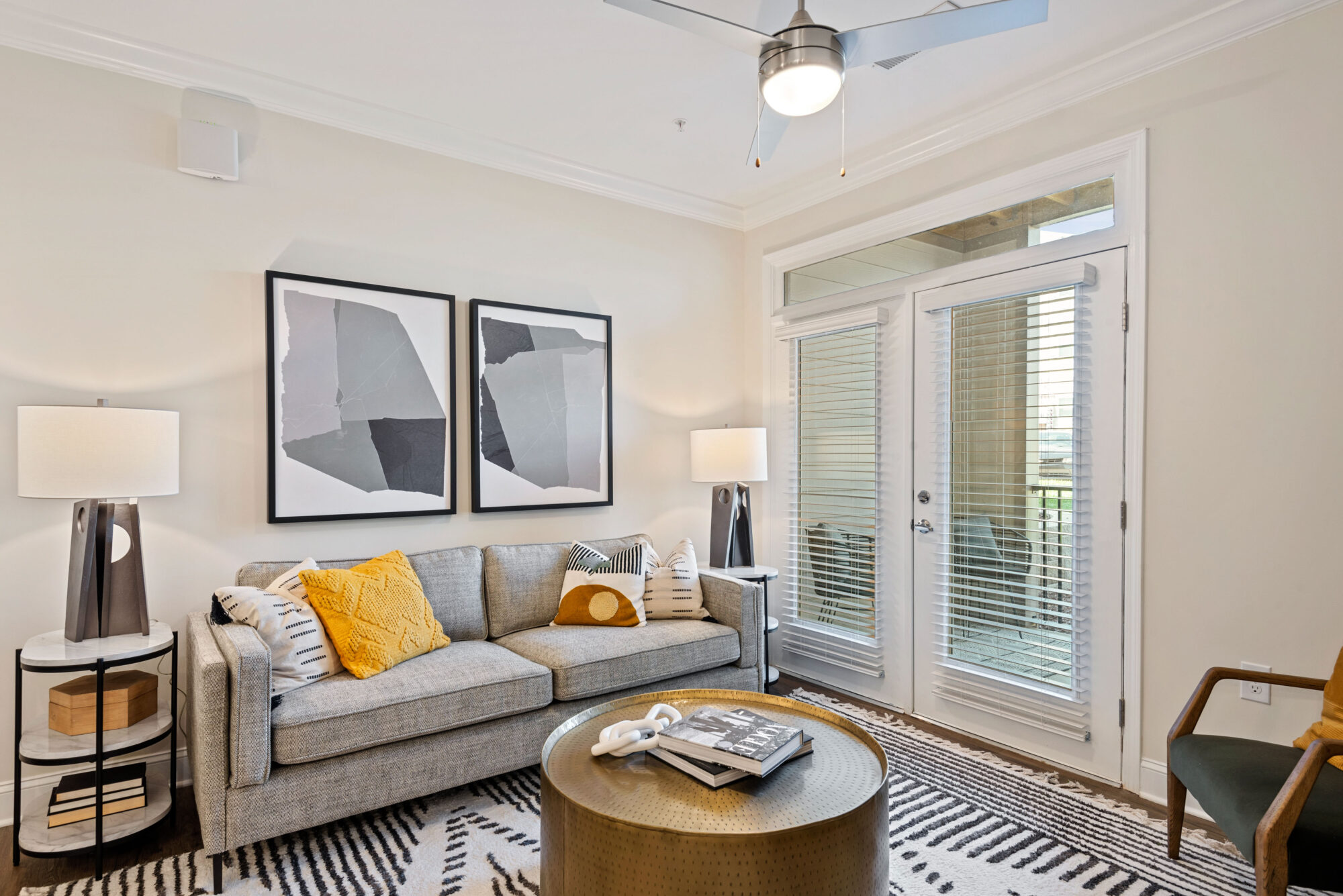 Living room with modern furnishings, door leading to patio