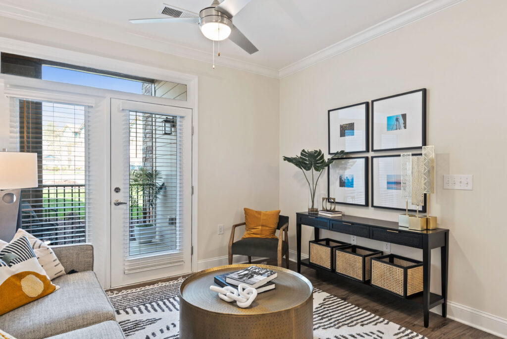 Living room with modern furnishings, door leading to patio